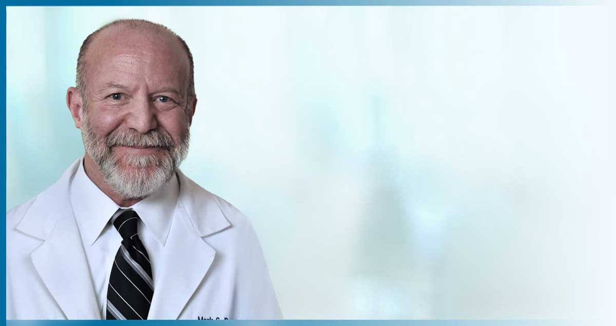 Man in white coat and tie
