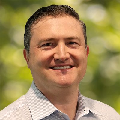 Man in white shirt, green backdrop